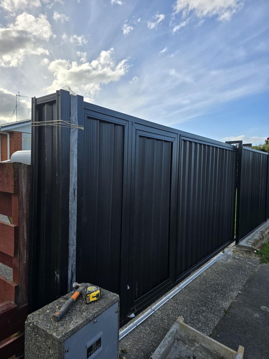 Matte-black sliding driveway gate built by Southland Forge